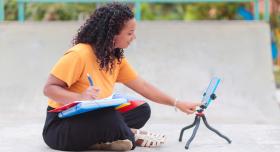 Student using a tablet on an outdoor project