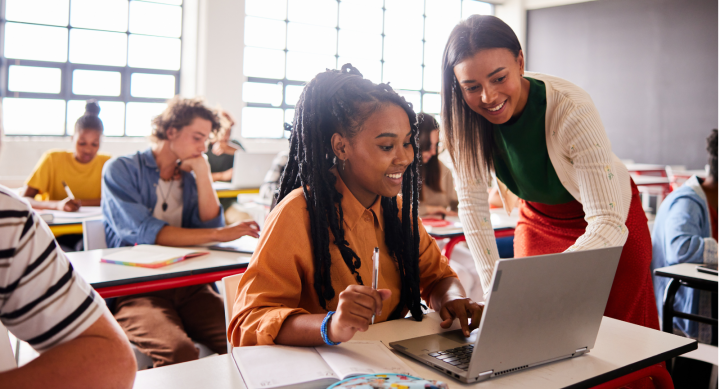 Photo of students and teacher with computers